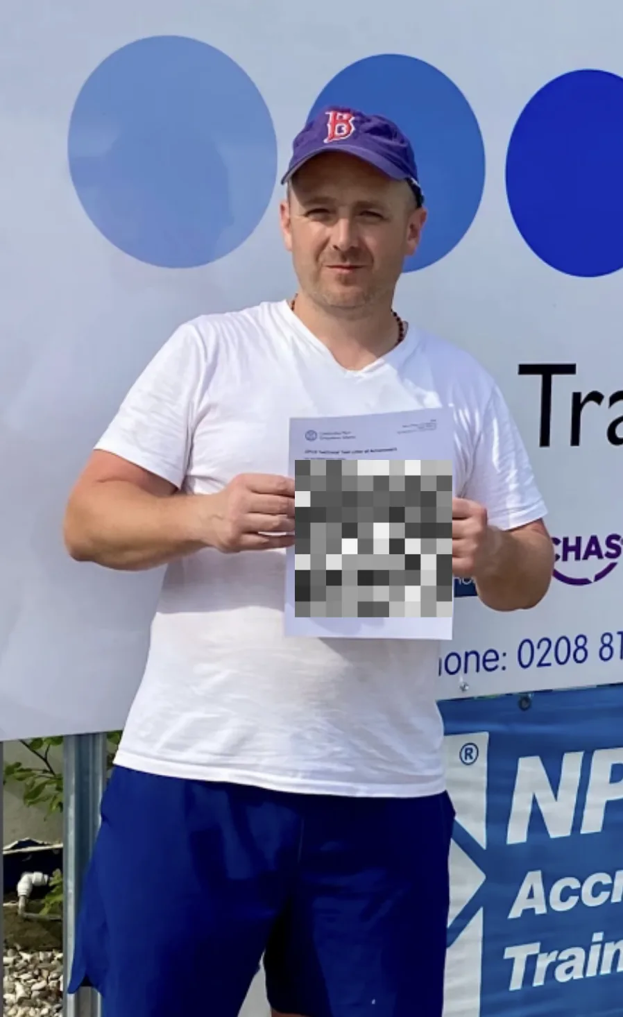 Student holding his course paperwork outside the training centre