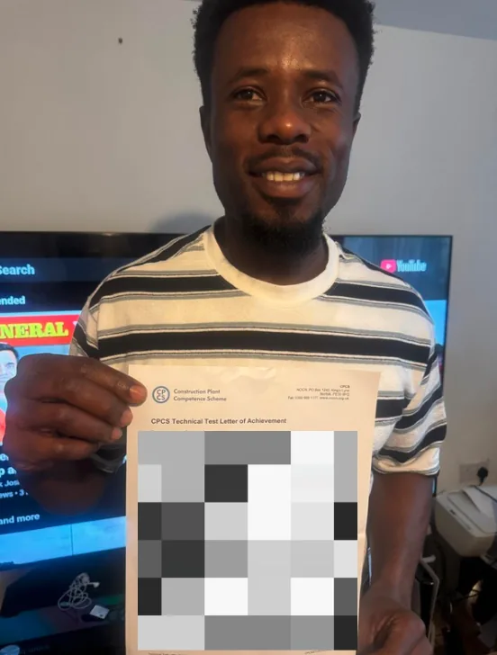 Student holding his CPCS technical test letter of achievement at home